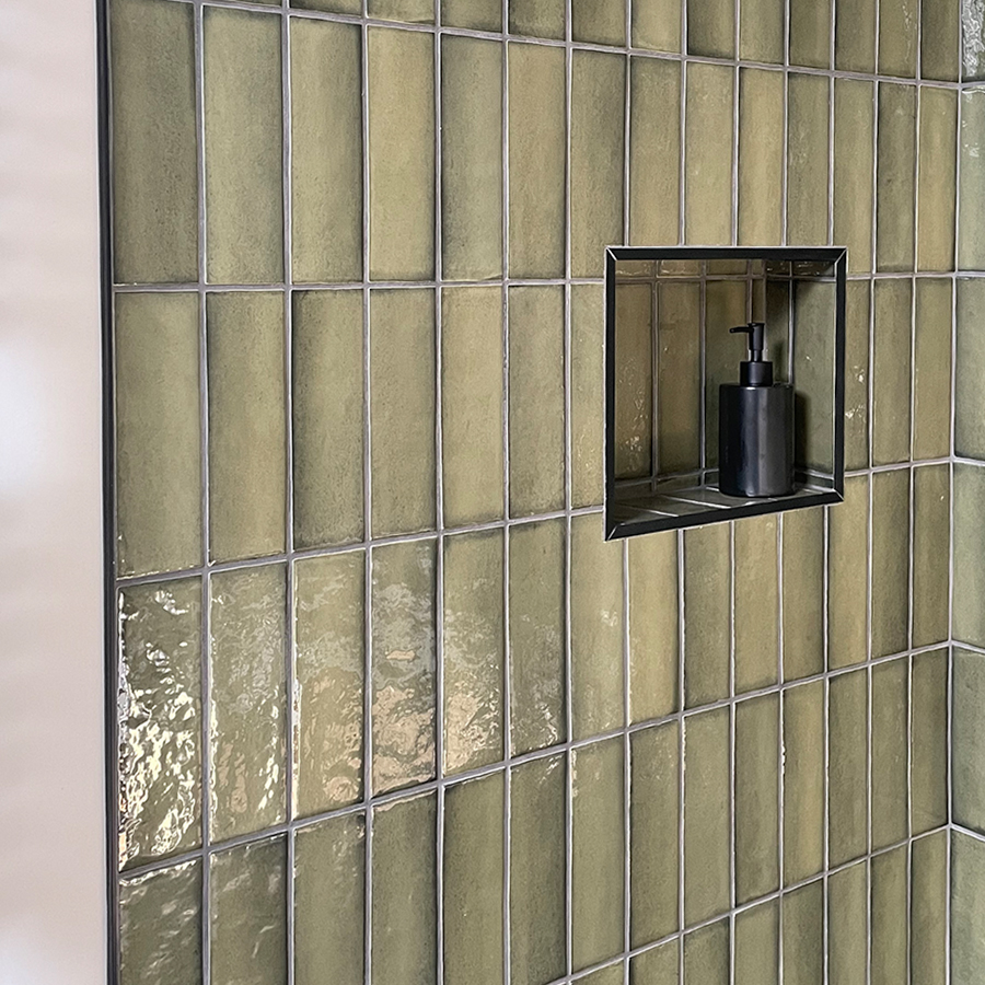 Green shower metro tiles with a black edge tile trim